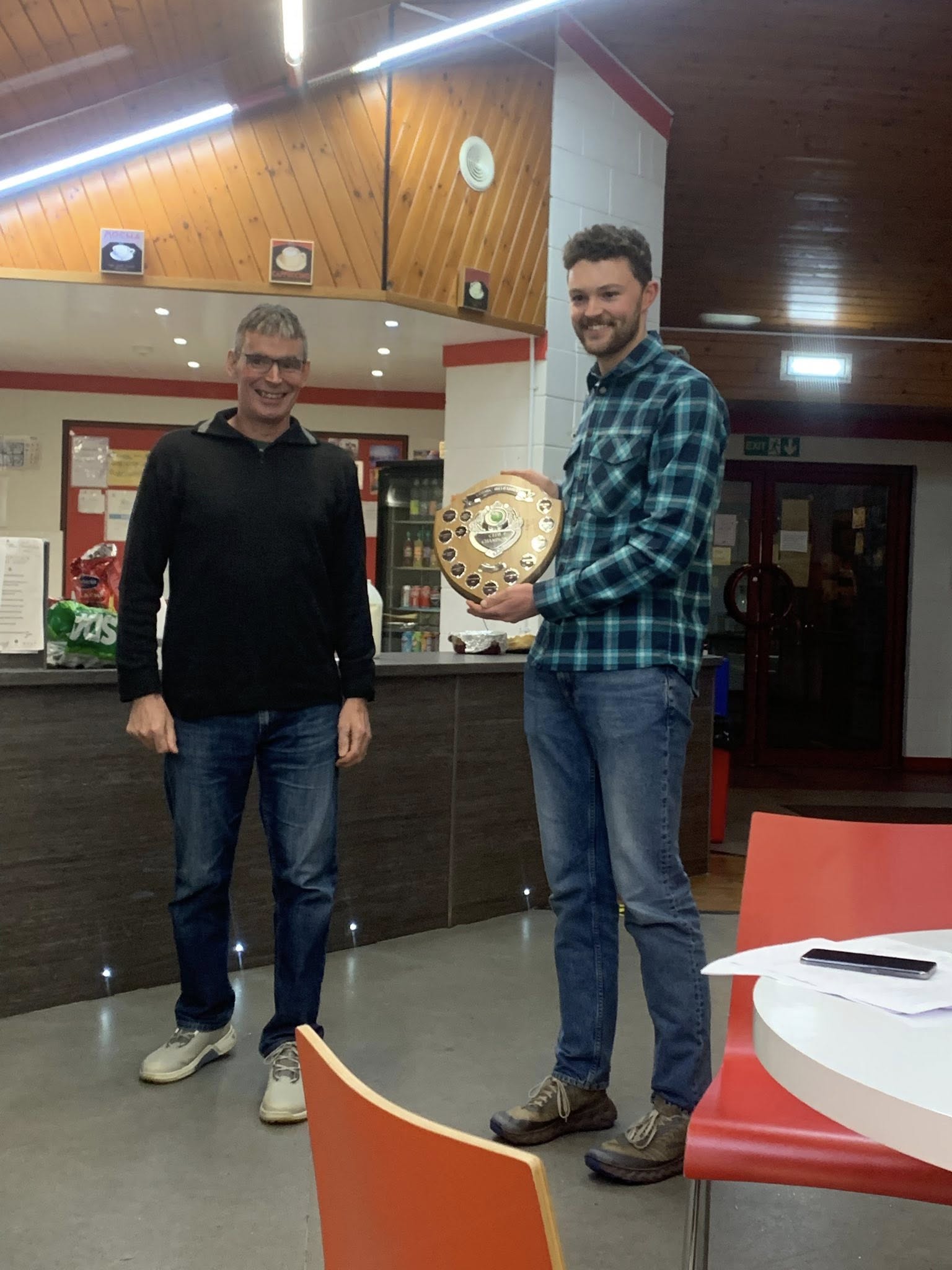 Iain Campbell receives the mens trophy from Richard Lang